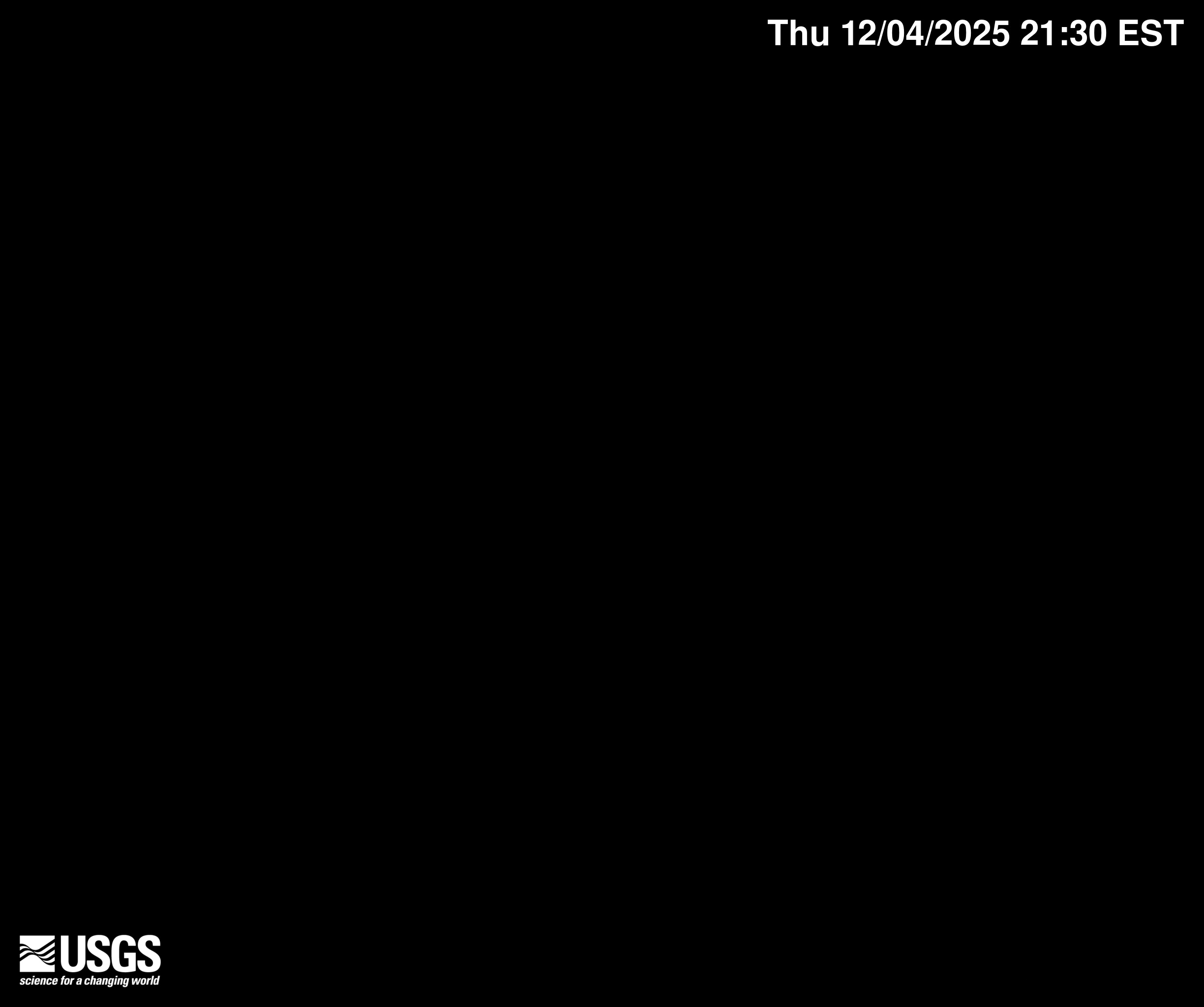 View of a sandy beach with gentle waves.